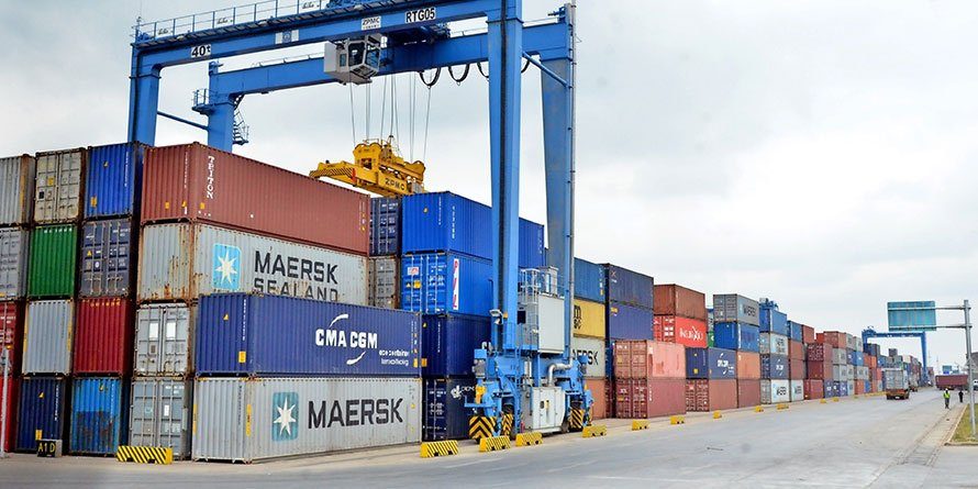 Containers stacked at a container yard with a gantry crane
